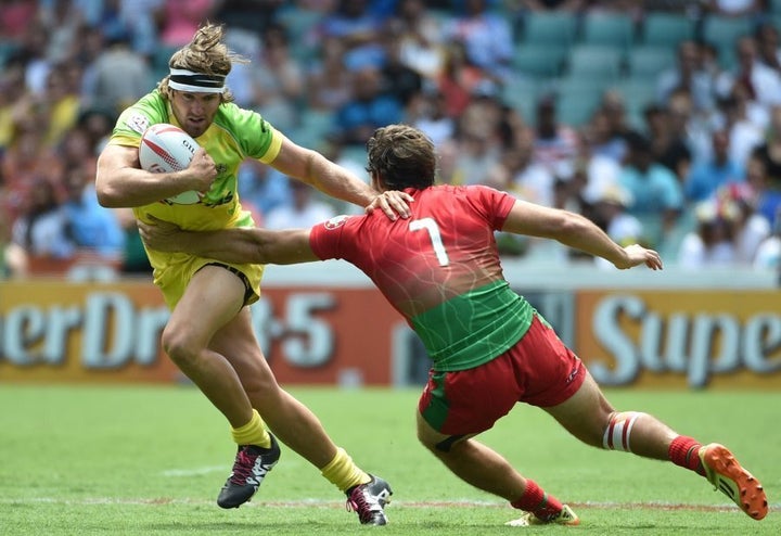 Rugby Sevens player Charlotte Caslick and her partner Lewis Holland pose  for a photograph at the 