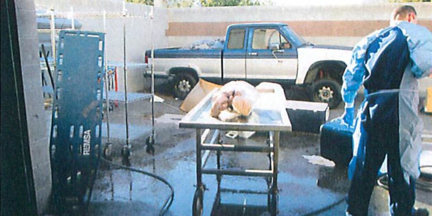 Officials wheel away a stretcher containing a human torso found being thawed with a hose at a facility rented by Southern Nevada Donor Services in Las Vegas.