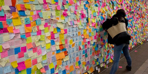 New Yorkers shocked and angered by the unexpected election of Donald Trump as President leave messages on colored note paper on the wall of the Union Square subway station in Manhattan on November 22, 2016.