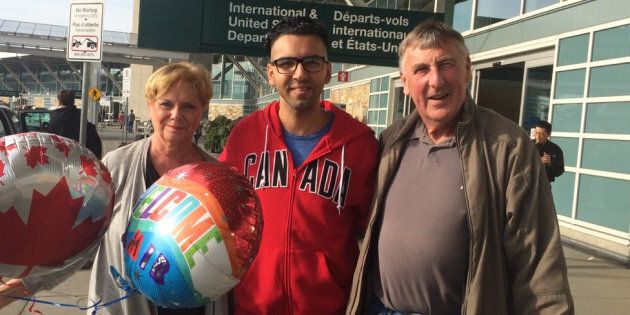 Amir (centre) with Wayne and Linda Taylor, after arriving in Canada