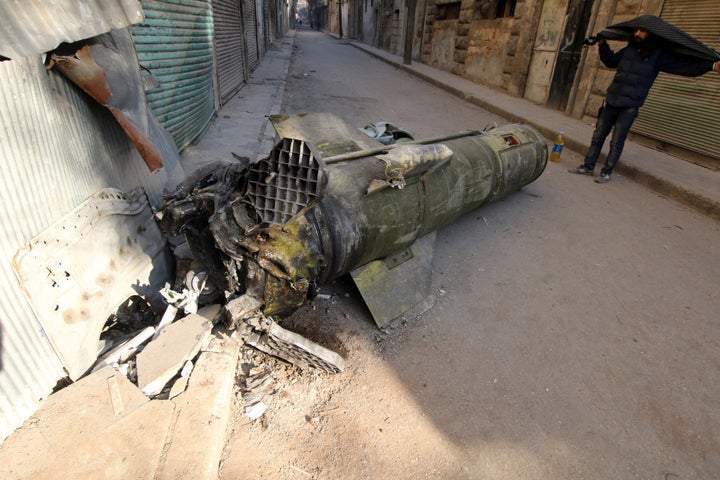 A man inspects an unexploded missile in the rebel-held besieged al-Qaterji neighbourhood of Aleppo, Syria November 28, 2016