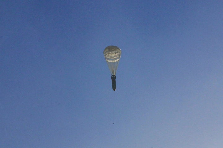 A missile hangs on a parachute while falling over the rebel-held besieged al-Qaterji neighbourhood of Aleppo, Syria November 28, 2016.