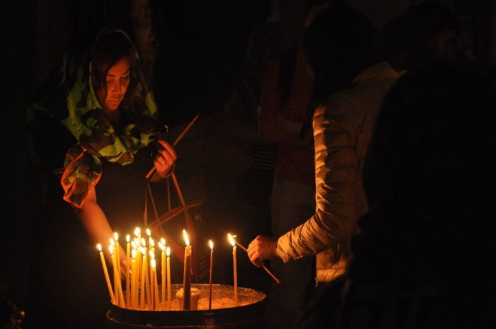 A woman worships inside the Church of the Holy Sepulchre In Jeruselam's old city.