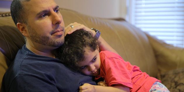 North Carolina resident Shadi Sadi holds his 5-year-old daughter Saja while watching the news at home on the morning after the election.