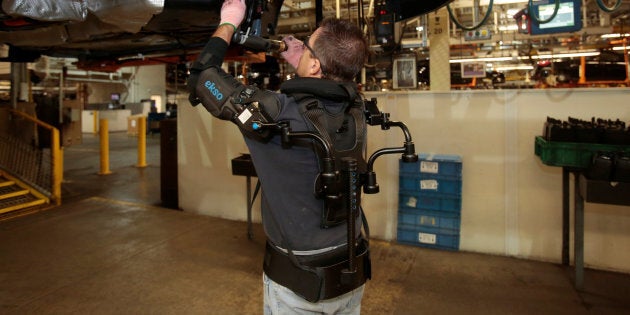 Ford assembly worker Paul Collins wears an EksoVest as he works on the assembly line producing the Ford Focus and C-max at Wayne Assembly plant in Wayne, Michigan.