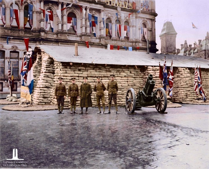 A group of troops before sandbags on Parliament Hill in Ottawa.