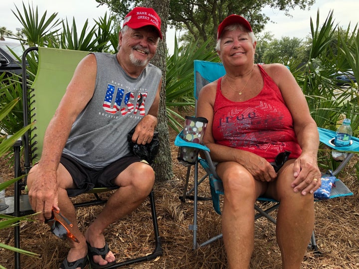 Ronnie and Beth Thompson sit outside while waiting for President Donald Trump's rally to start in Panama City Beach, Florida.