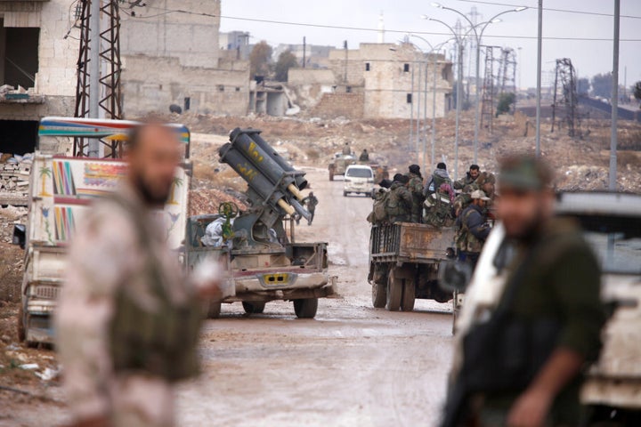 Syrian government soldiers gather in Al-Haidariya neighbourhood after government forces took control of the area in Aleppo, Syria December 2, 2016.