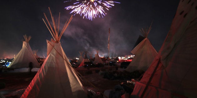 Fireworks fill the night sky above Oceti Sakowin Camp as activists celebrate after learning an easement had been denied for the Dakota Access Pipeline near the edge of the Standing Rock Sioux Reservation on December 4, 2016 outside Cannon Ball, North Dakota.