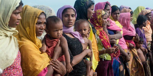 Women hold children at a makeshift camp in Rakhine state in Myanmar.