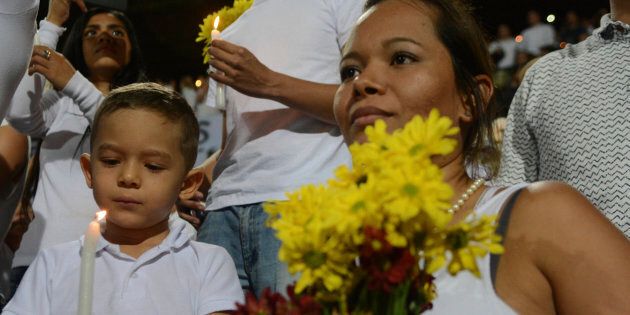 Colombians like this boy and his mother were all supportive of Chapecoense being awarded the Cup.