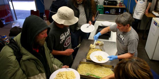 Homeless people are seen using the Meals at the Bridge Service in Melbourne