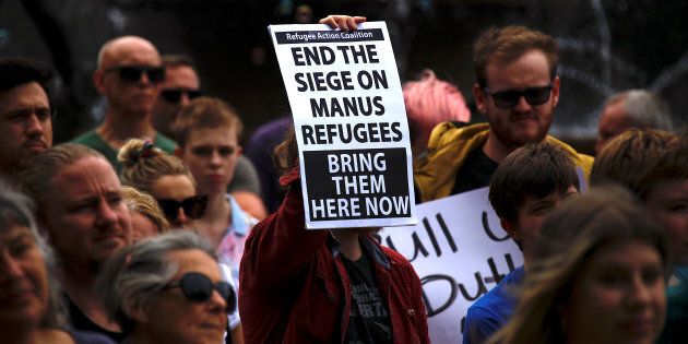 Refugee advocates hold placards as they participate in a protest in Sydney, Australia, against the treatment of asylum-seekers.