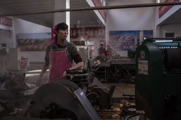 A worker processes silk at the Kim Jong Suk Silk Mill in Pyongyang.