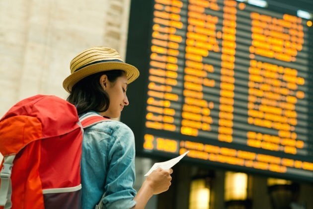 Young woman checking her train in time board