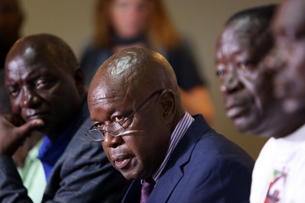 Chris Mutsvangwa, center, head of the Zimbabwe War Veterans Association, speaks during a news conference to announce the start of impeachment proceedings against Robert Mugabe.