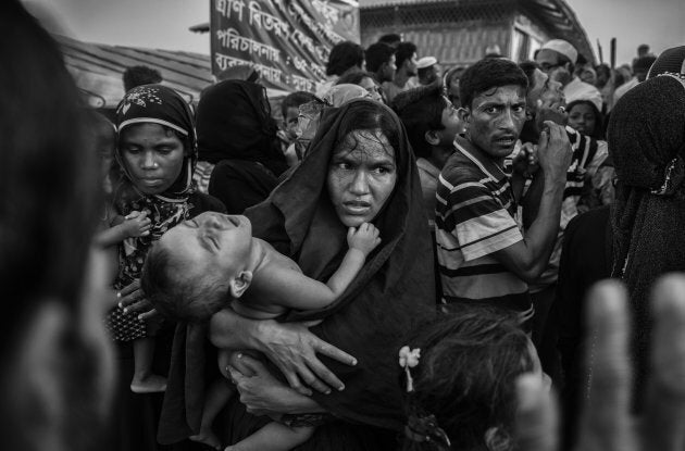 A Rohingya refugee woman struggles in the crowd at the Kutupalong refugee camp near Cox's Bazar, Bangladesh.