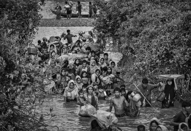 Rohingya Muslim refugees crowd a canal as they flee over the border from Myanmar into Bangladesh at the Naf River on November 1, 2017 near Anjuman Para in Cox's Bazar, Bangladesh.