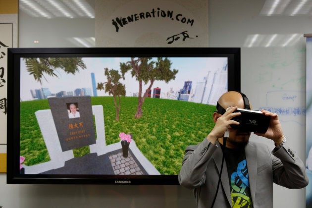 Anthony Yuen, CEO of iVeneration.com, demonstrates an augmented reality graveyard at his office in Hong Kong.