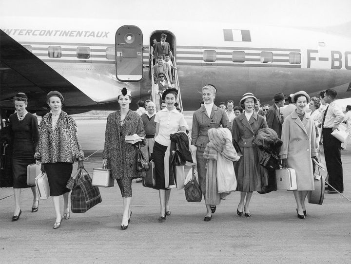 Christian Dior models arriving in Australia for the presentation of the autumn−winter 1957 haute couture collection, Christian Dior's last collection, at Myer Mural Hallin Australia, November 1957.