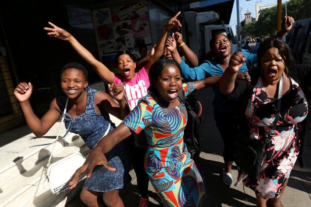 Zimbabweans celebrate in the morning sun after President Robert Mugabe resigned in Harare, Zimbabwe.