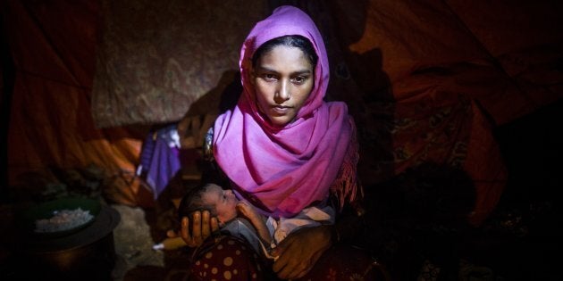 October 11, 2017: Nur Kayida, 20, is seen with her two-day-old baby with no given name at a makeshift camp in Cox's Bazar, Bangladesh.