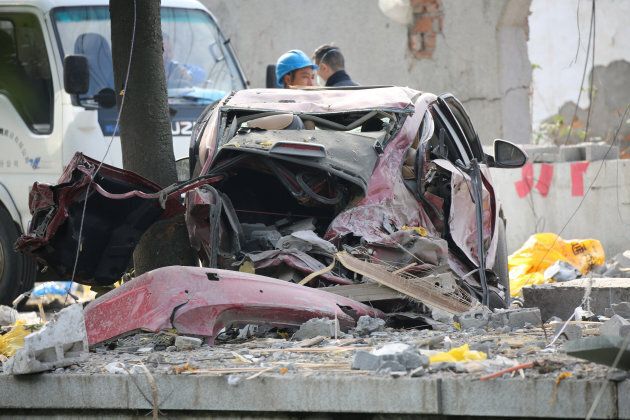 A damaged car is seen at the site of a blast in Ningbo.