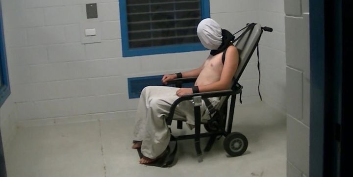 Dylan Voller is strapped to a restraint chair and a 'spit hood' placed on his face. on Monday he told a Royal Commission he vomited into his own mouth while in the chair