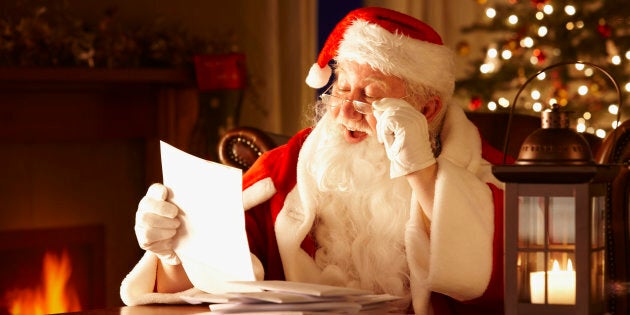 Portrait of Father Christmas Reading letters from children in his grotto