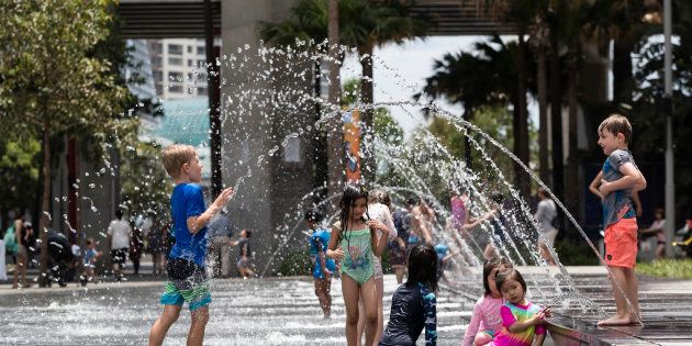 Families take refuge from the heat at Darling Harbour on January 8, 2018 in Sydney, Australia. Sydney was the hottest place on earth yesterday, with temperatures reaching 47.3C in some suburbs, a recording not seen since 1939.