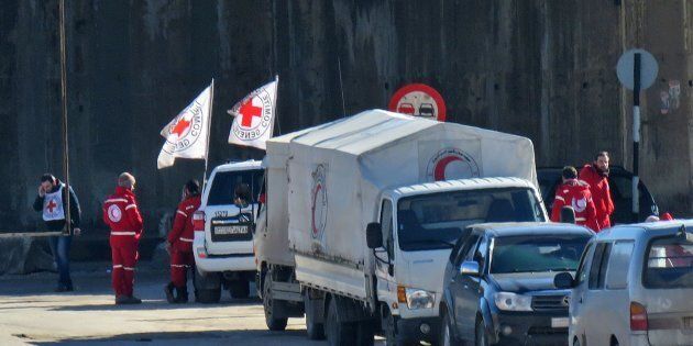 Staff from the International Red Cross and from the Syrian Red Crescent are seen in embattled city of Aleppo as efforts were underway to evacuate rebel fighters and their families from rebel-held areas on December 15, 2016.Russia, Syrian military sources and rebel officials confirmed that a new agreement had been reached after a first evacuation plan collapsed the day before amid fresh fighting. Syrian state television reported that some 4,000 rebels and their families were to be evacuated. / AFP / STRINGER (Photo credit should read STRINGER/AFP/Getty Images)