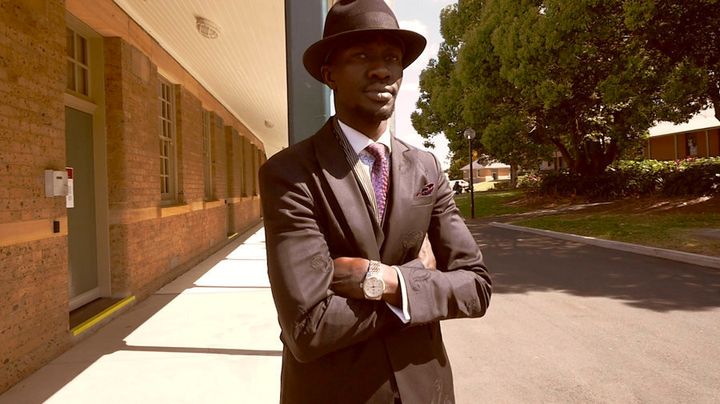 Deng Adut has eight hats on rotation and three different tailors across Sydney.