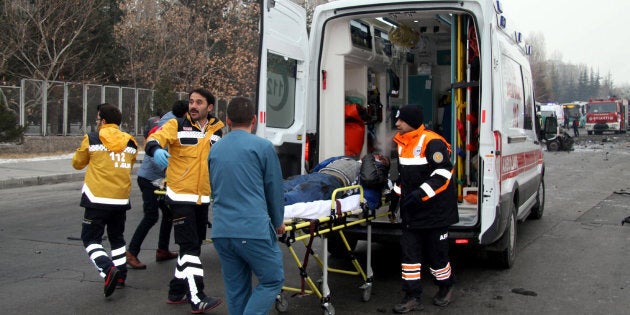 TURKEY OUTThis picture obtained from the Ihlas News Agency shows a police officer and people walking next to the wreck of public bus following an explosion on December 17, 2016 in Kayseri, central Turkey.Several people were wounded on December 17 in a car bombing close to the public bus in the central Turkish city of Kayseri, television reports said. The Dogan news agency said that the blast took place opposite the Erciyes University in the city. NTV television said there could be fatalities as a result of the blast. The state-run Anadolu news agency said that the bus was owned by the municipal transport authorities in Kayersi but was transporting Turkish soldiers who had taken permission to go to a local market for the day. / AFP / IHLAS NEWS AGENCY / IHLAS NEWS AGENCY / Turkey OUT (Photo credit should read IHLAS NEWS AGENCY/AFP/Getty Images)