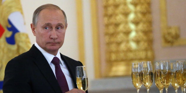 MOSCOW, RUSSIA - NOVEMBER 9: (RUSSIA OUT) Russian President Vladimir Putin takes a glass of champagne during the reception for new foreign ambassadors at Grand Kremlin Palace on November 9, 2016 in Moscow, Russia. Putin has received credentials from 19 new foreign ambassadors and also extended congratulates to Donald Trump the winner of U.S. Presidential election today. (Photo by Mikhail Svetlov/Getty Images)