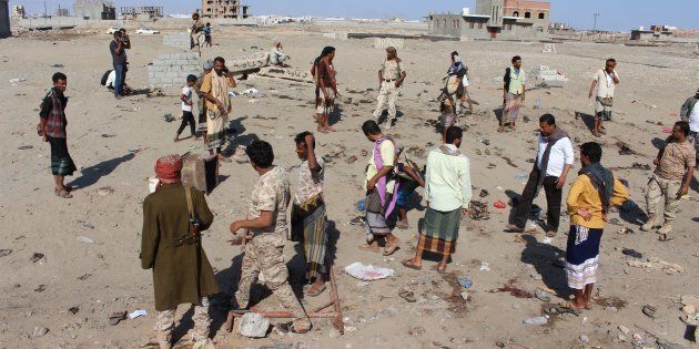 Yemenis gather at Hur Mekser region in Aden on December 18, 2016, after a suicide bomber targeted a crowd of soldiers. (Photo by Wail Qubati/Anadolu Agency/Getty Images)