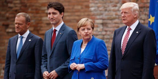 Leaders of the G7, from left, European Council President Donald Tusk, Prime Minister Justin Trudeau, German Chancellor Angela Merkel, and President Donald Trump pose for a family photo at the Ancient Greek Theater of Taormina on May 26, 2017, in Taormina, Italy.