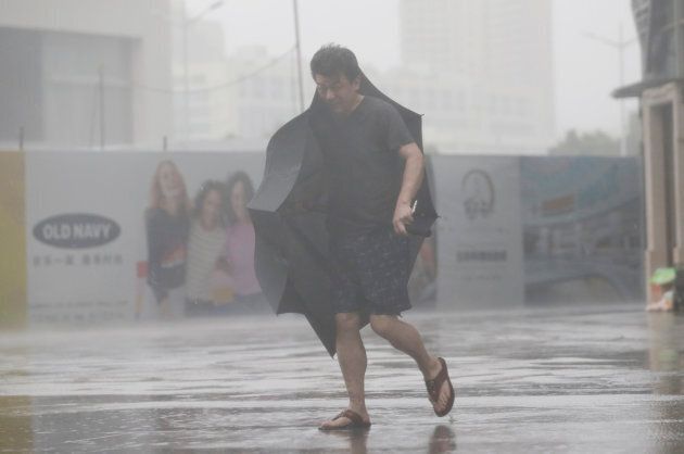 A man holding an umbrella walks in rain as Typhoon Mangkhut approaches, in Shenzhen, China.