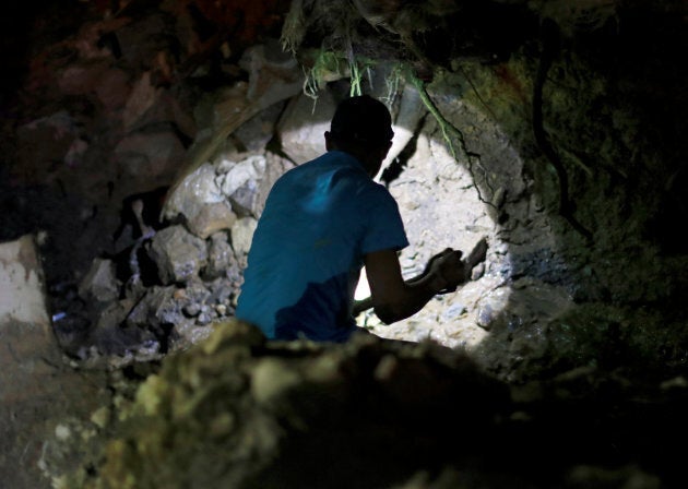 A miner takes part during a search for fellow miners missing after a landslide caused by Typhoon Mangkhut at a small-scale mining camp in Itogon, Benguet, Philippines.