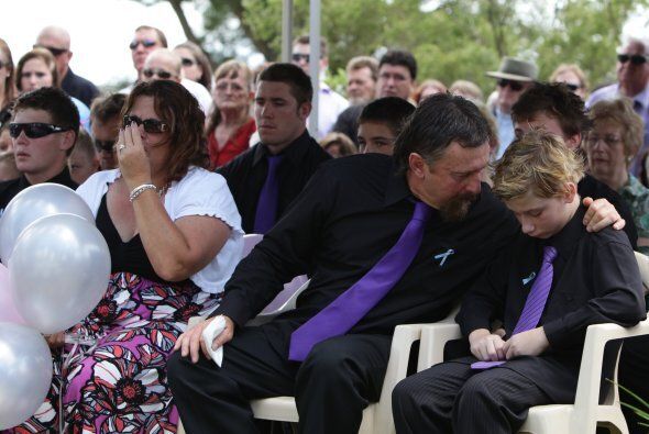 John Rice comforts his son Kyle at the funeral of his brother Jordan Lucas Rice and mother Donna Maree Rice.