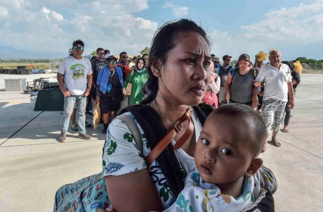 People injured or affected by the earthquake and tsunami wait to be evacuated on an air force plane in Palu, Central Sulawesi, Indonesia, September 30, 2018.