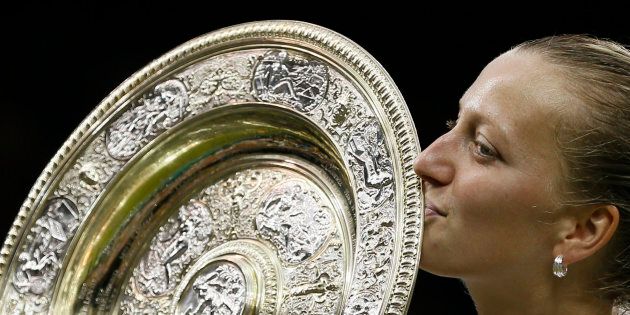 Petra Kvitova of Czech Republic kisses the winner's trophy, the Venus Rosewater Dish, after defeating Eugenie Bouchard of Canada in their women's singles final tennis match at the Wimbledon Tennis Championships in London July 5, 2014. REUTERS/Stefan Wermuth (BRITAIN - Tags: SPORT TENNIS)