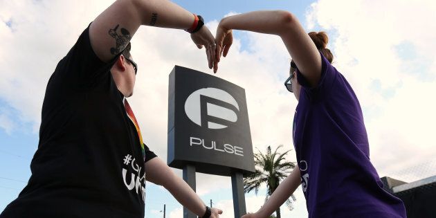 FILE PHOTO -- Heather Raleigh (L) and Paige Metelka make a heart shape as they pose during a photo shoot outside Pulse nightclub following the mass shooting last week in Orlando, Florida, U.S., June 21, 2016. REUTERS/Carlo Allegri/File Photo