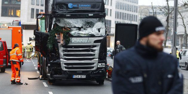 Security and rescue workers tend to the area after a lorry truck ploughed through a Christmas market on December 20, 2016 in Berlin, Germany.