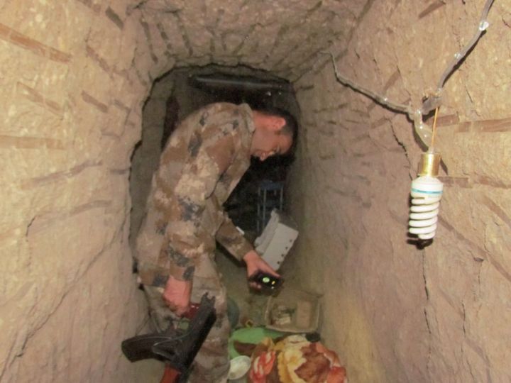 A Peshmerga leads me through the tunnel.