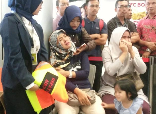 Relatives of passengers of Lion Air flight JT610 that crashed into the sea, cry at Depati Amir airport in Pangkal Pinang, Indonesia.