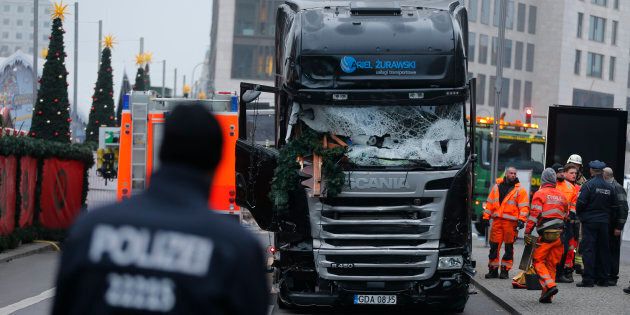 Police stand in front of the truck which ploughed last night into a crowded Christmas market in the German capital Berlin, Germany, December 20, 2016. REUTERS/Hannibal Hanschke