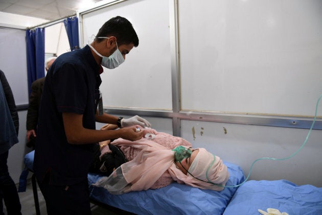 A woman breathes through an oxygen mask after what the Syrian state media said was a suspected toxic gas attack in Aleppo, Syria November 24, 2018.