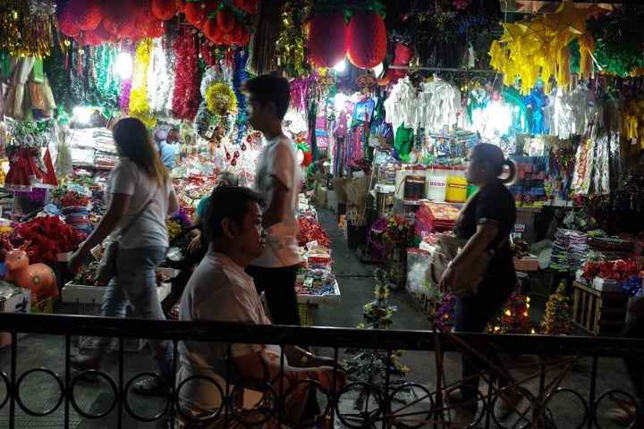 A man arranges a small Christmas tree at a dry market in Quezon City, east of Manila.