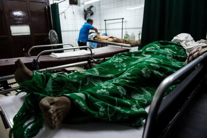 Workers process bodies at a morgue in Manila in early December.