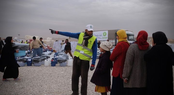 Oxfam staff organise the distribution of supplies to IDPs in Hassansham Camp, about 50km East of Mosul